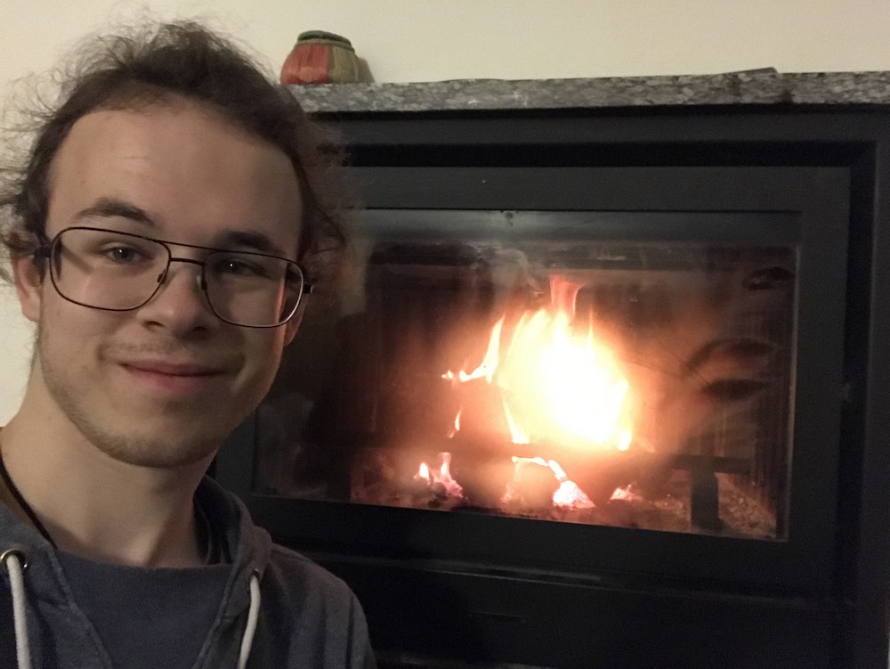 Me in front of a lit fireplace